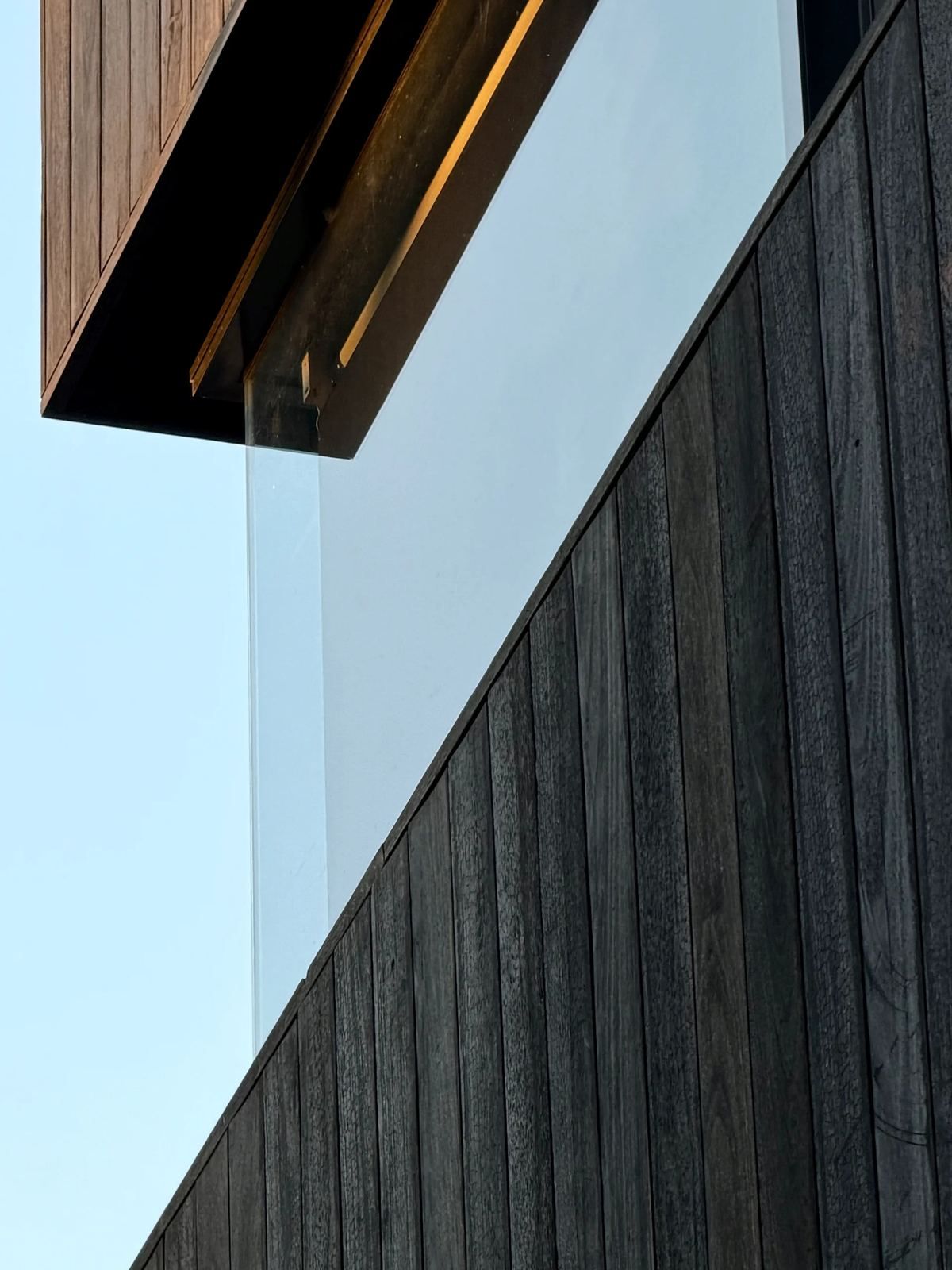 Shou sugi ban burnt timber cladding against glazing, Crystal Street, Sylvania